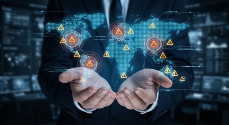 A person in a suit holds out hands with a digital map of the world displaying warning symbols over various global locations, highlighting the importance of secure IT disposal services provided by trusted IT asset recycling companies.
